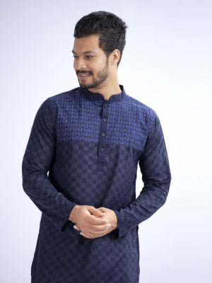 Blue semi-fitted Panjabi in Cotton fabric. Designed with a mandarin collar and matching metal buttons on the placket. Embellished with minimal embroidery on the chest.