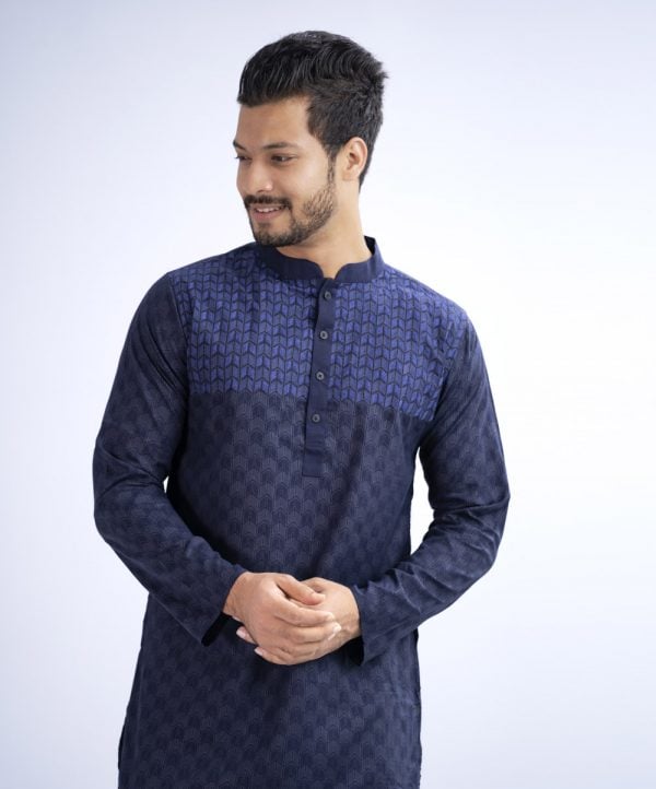 Blue semi-fitted Panjabi in Cotton fabric. Designed with a mandarin collar and matching metal buttons on the placket. Embellished with minimal embroidery on the chest.