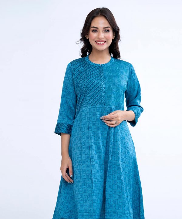 Blue all-over printed Tunic in Crepe fabric with low mock neck and 3 quarter sleeves.