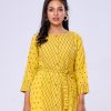 Yellow all-over printed A-line Tunic in Georgette fabric. Features a round neck with front button opening and three-quarter sleeves. Tie-waist belts at the front. Patch attachment at the cuffs.