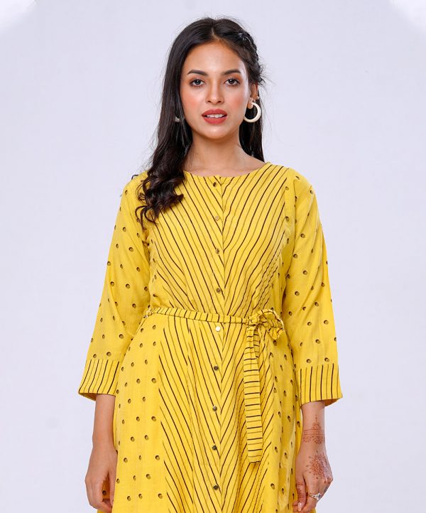 Yellow all-over printed A-line Tunic in Georgette fabric. Features a round neck with front button opening and three-quarter sleeves. Tie-waist belts at the front. Patch attachment at the cuffs.