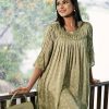 Green A-line woven Top in printed Georgette fabric. Designed with a round neck and three-quarter sleeves. Embellished with pin tucks at the front and sleeves. Unlined.