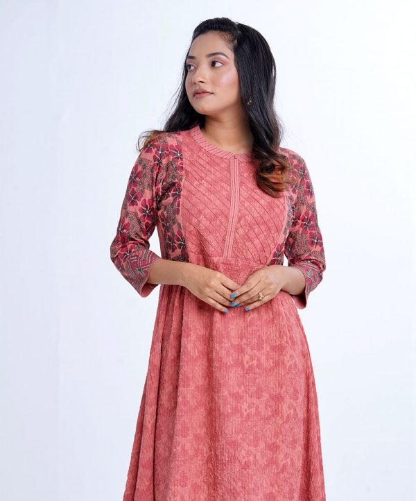 Peach all-over printed A-line Tunic in Georgette fabric. Features a band collar with hook closure at the front and three-quarter sleeves. Embellished with diamond shaped pin tuck stitches at the top front and gathers from the waistline. Patch attachment at the hemline. Unlined.