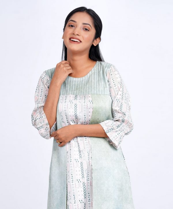 Mint and White all-over printed layered A-line Tunic in Crepe fabric. Designed with a round neck and poet Sleeves. Embellished with pin tucks at the top front. Single button opening at the back. Unlined.