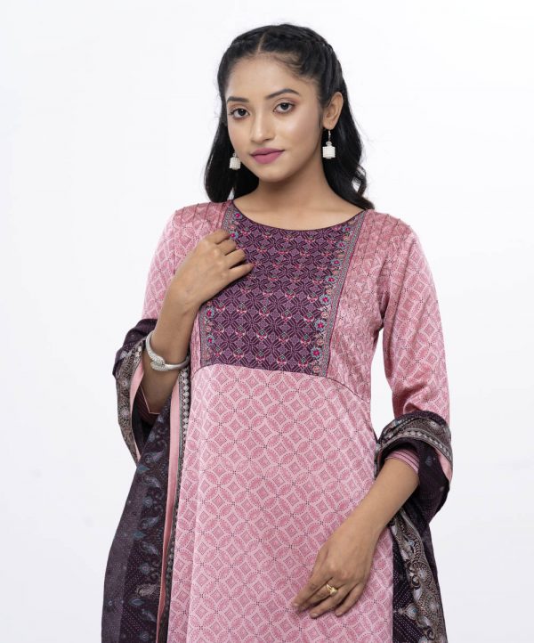 Pink and burgundy all-over printed Salwar Kameez in Crepe fabric. the Kameez is designed with a round neck and three-quarter sleeves. Embellished with embroidered patch attachment at the top front. Complemented by palazzo pants and a half-silk dupatta.