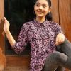 Black ladies Shirt in printed Georgette fabric. Features a classic Collar and roll-up sleeve. Gathers from the waistline. Unlined.