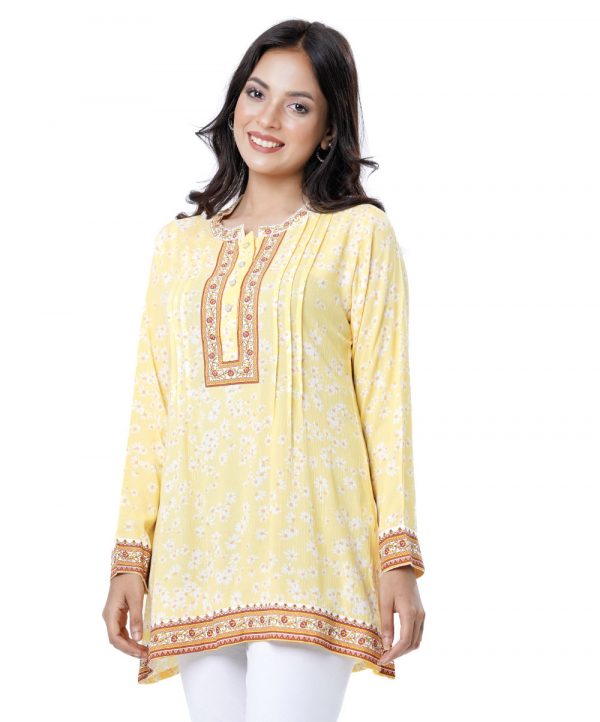 Yellow A-line Tunic in printed Cotton fabric. Features a band neck with hook closure at the front and long sleeves. Embellished with pin tucks at the top front.