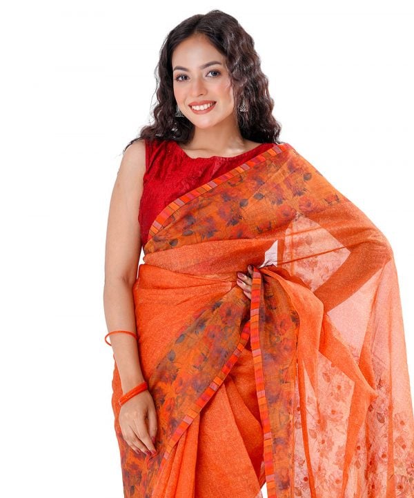 Orange all-over printed exclusive Saree in Muslin fabric with a matching border. Embellished with karchupi, and decorative tassels on the achal.