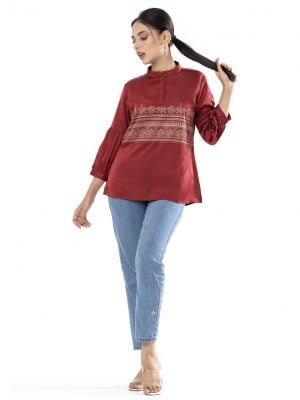 Maroon A-line Top in Crepe fabric. Designed with a band neck and lantern sleeves. Beautyful printed at the top front.