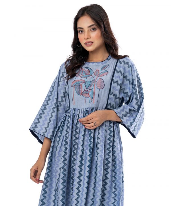 Blue all-over printed gathered Tunic in Cotton-blend fabric. Designed with a round neck and kimono sleeves. Embellished with embroidery at the top front. Button opening at the back.