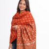 Brick orange all-over printed Shawl in Cotton viscose fabric. Features fringe trim on both sides.