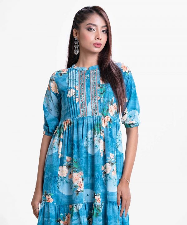 Women's frock style long tunic in printed georgette fabric. Band neck, three quarter sleeves and pin tuck at front.