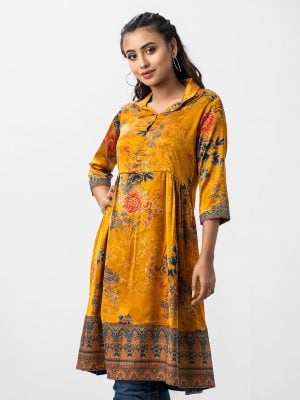 Women's frock style tunic in printed georgette fabric. Lapel collar, three-quarter sleeved. Box pleated from the waistline and attached patch work.