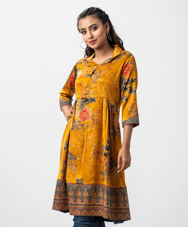 Women's frock style tunic in printed georgette fabric. Lapel collar, three-quarter sleeved. Box pleated from the waistline and attached patch work.