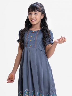 Kid girls frock in crepe fabric. Puff sleeved, colorful stitching and buttons at front. Box pleats at waist.