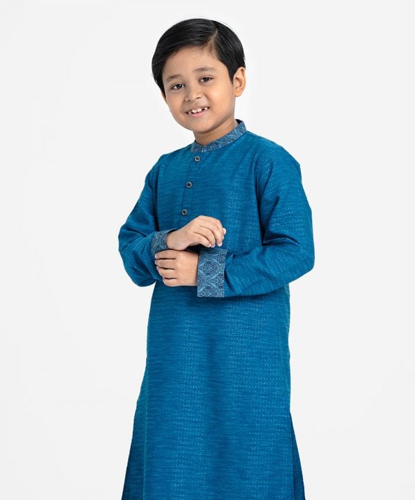 Kid boys panjabi in Jacquard fabric. Patchwork at mandarin collar and full sleeves hem. Inseam pockets.