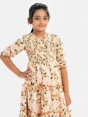 Kids girl layer style frock in printed georgette fabric. Round neck, puff-sleeved. Smokey and frill trim at the front.