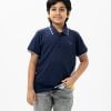 Kids boy polo shirt in cotton pique fabric. Classic collar with button placket and short sleeves.