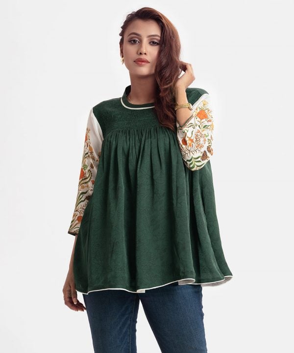 Printed Tent-style top in crepe fabric. Mock neck, three-quarter sleeved. Smokey and gathers at the top.