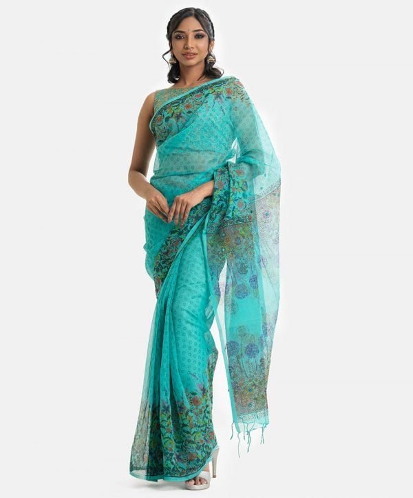 Floral printed saree in cotton fabric. Embellished with embroidery, and fringe trim at the border of anchal.