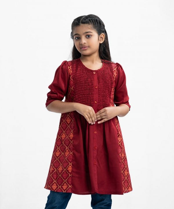 Kid girls tent-style A-line tunic in crepe fabric. Round neck, puff-sleeved. Smokey and gathered at the waistline. Button fastening at the front.