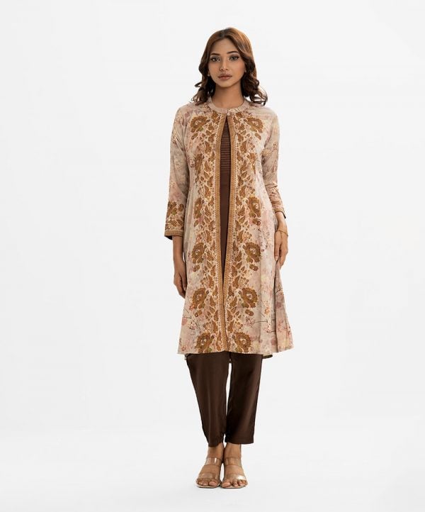 Women's printed A-line shrug style salwar kameez in jacquard fabric. Stand collar, long-sleeved with a button fastaning shrug. Crepe sleeveless kameez and round neck with line stitching at the front. Complemented with a crepe pant.